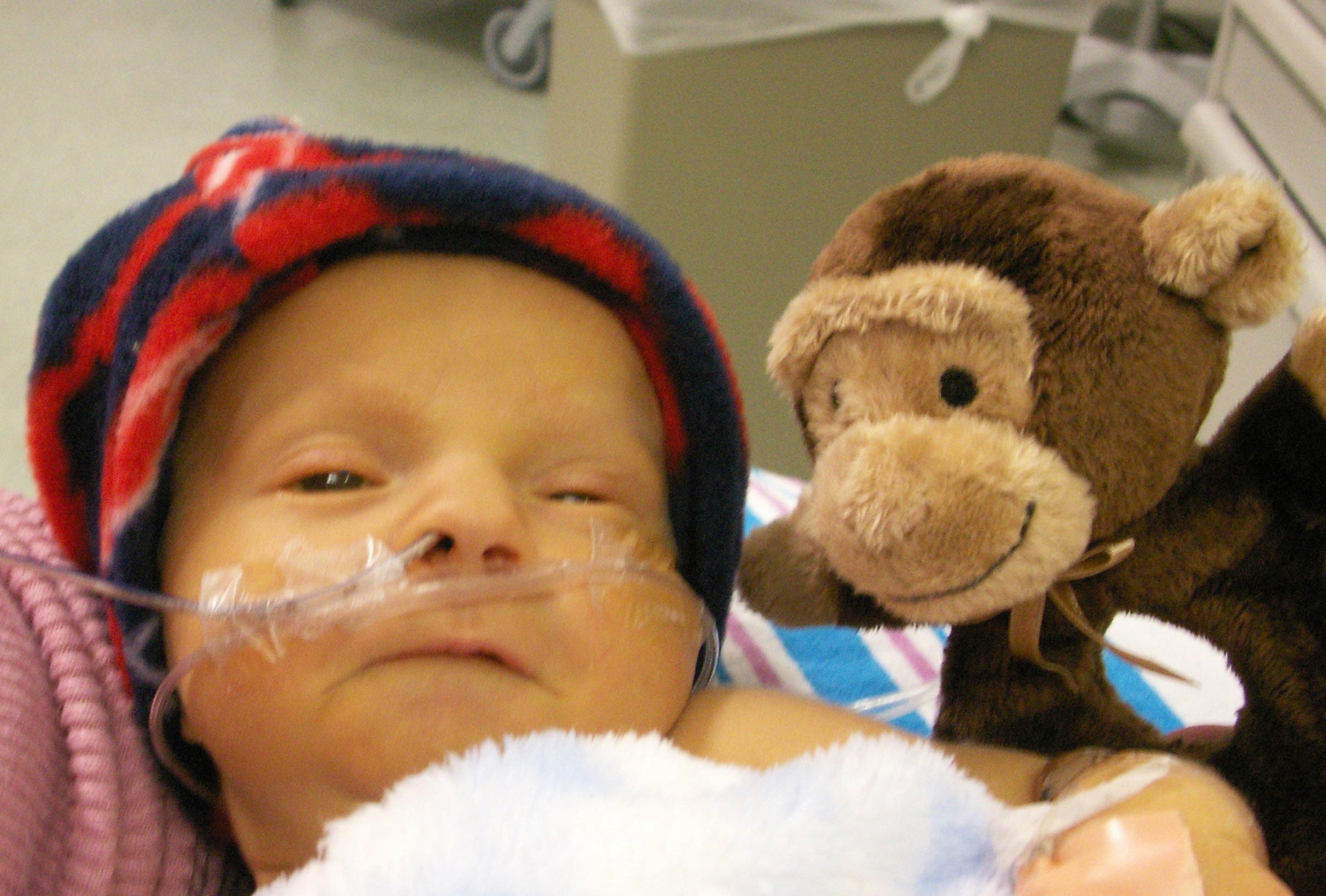 Baby Benjamin with his stuffed monkey